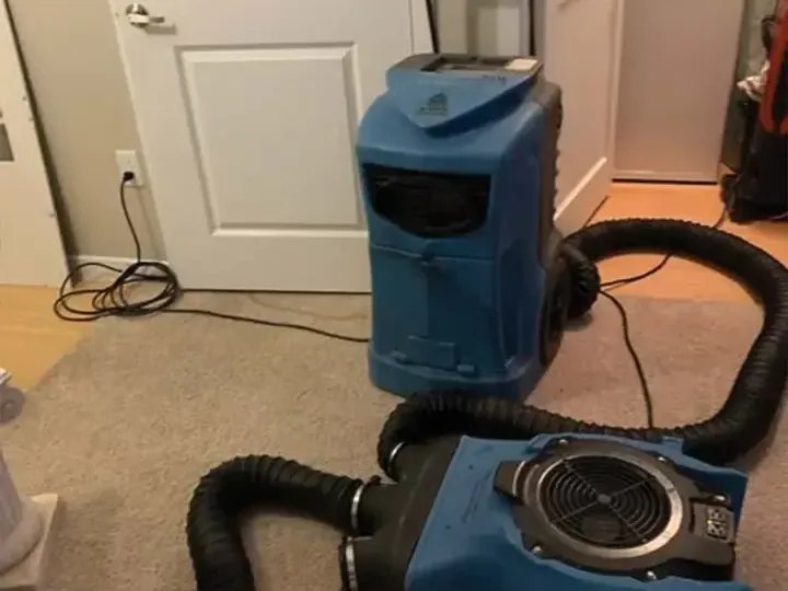 Dehumidifier and air mover with a drying duct in a carpeted room