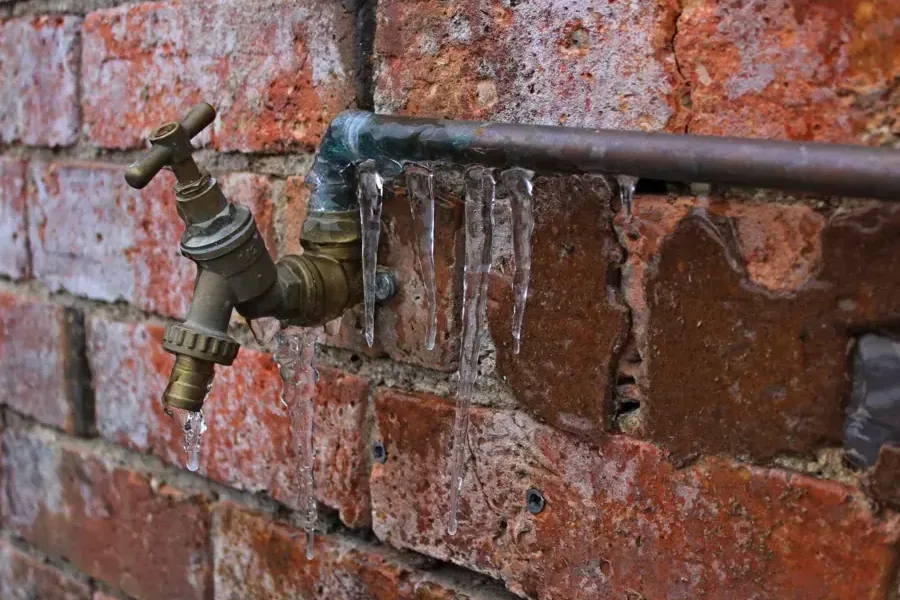 Outdoor spigots coated in ice during freezing weather