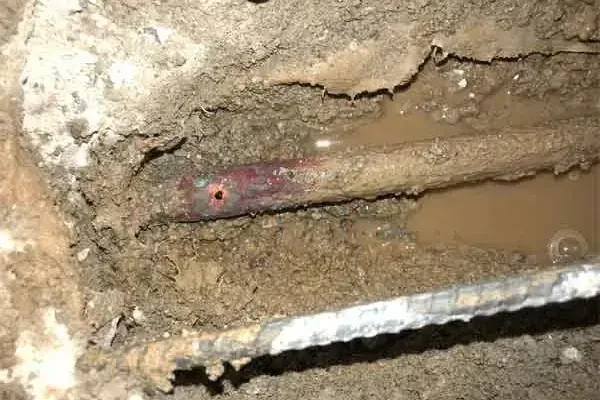Copper pipe exposed beneath an opened concrete floor