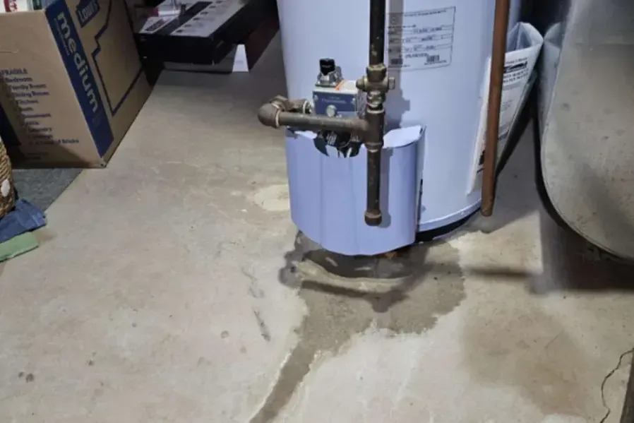Water pooled around the base of a water heater